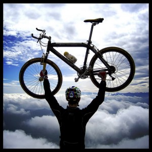 Man holding up a cross country mountain bike