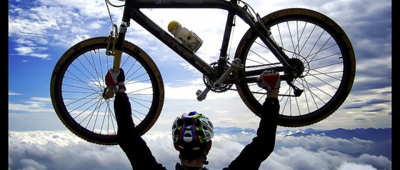 Man holding up a cross country mountain bike